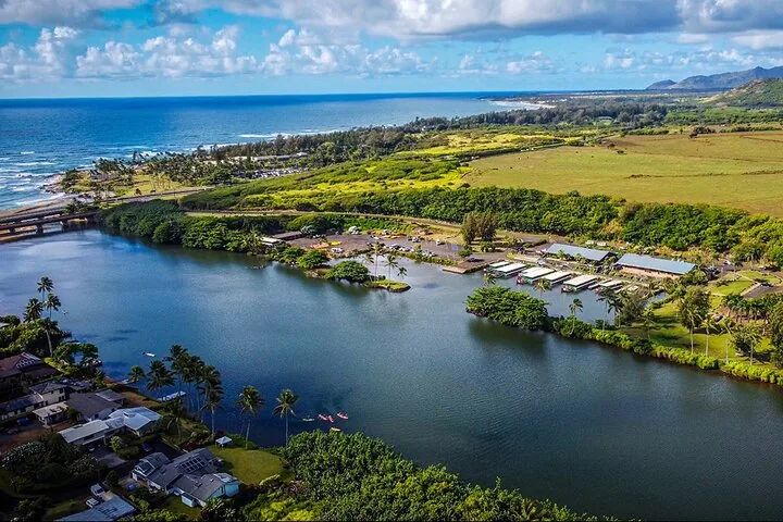 Aerial view of a river meeting the ocean with coastal development.